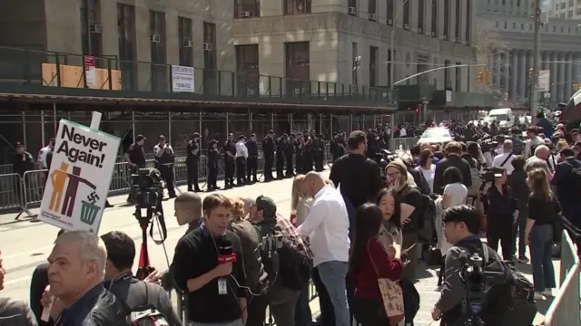 Protesters and supporters behind barricades outside the courthouse