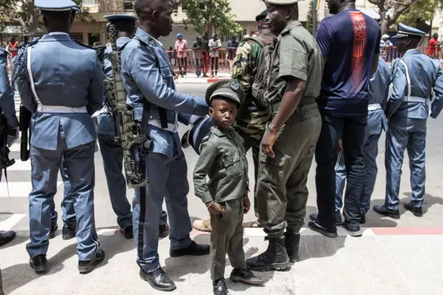 A young boy dressed in a military uniform is seen during celebrations for Senegals 63rd Independence Day in Dakar on 4 April.