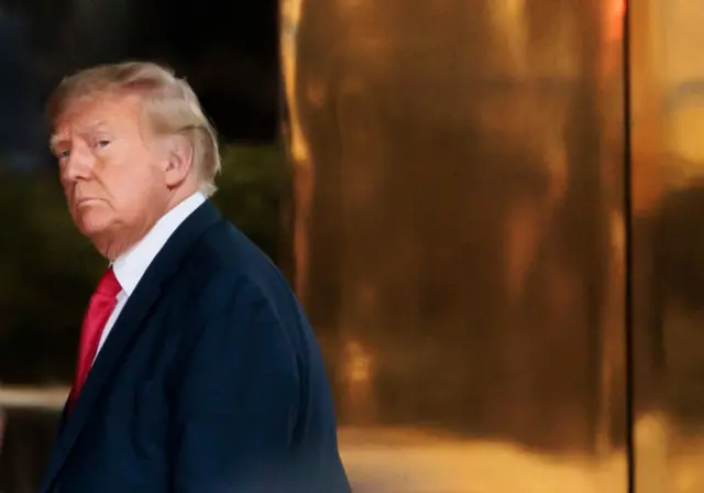 Donald Trump walks into Trump Tower in New York City