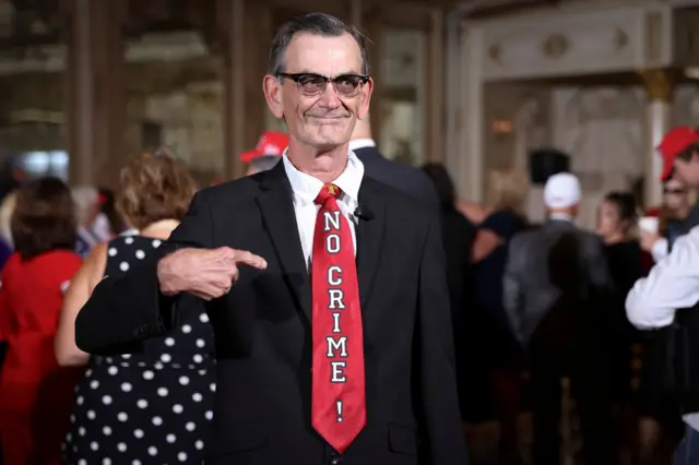A man with a tie that says 'No Crime'