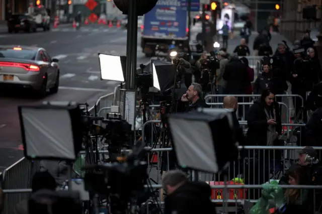 Members of the media work outside Trump Tower