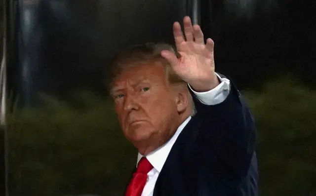 Donald Trump waves as he arrives at Trump Tower in New York on Monday 3 April