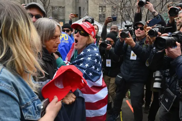 Pro and anti Trump supporters face off during a protest outside Manhattan Criminal Court in New York