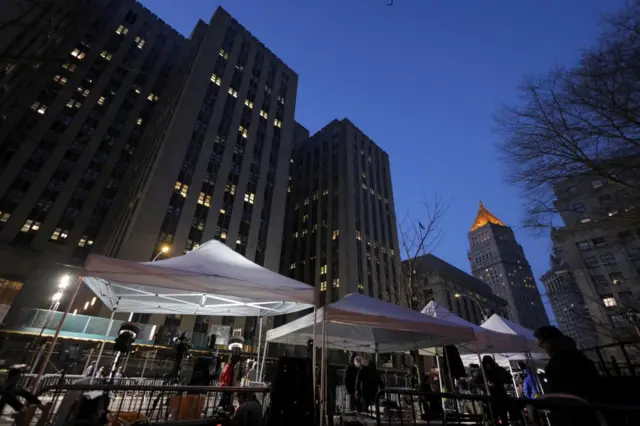 Members of the media work from tents outside Manhattan Criminal Courthouse