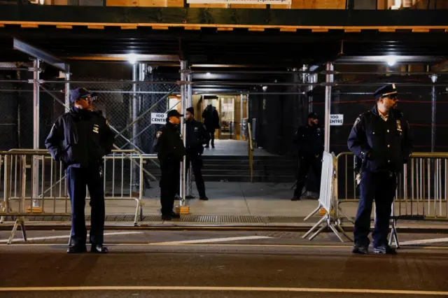 Law enforcement officers work near the Manhattan criminal courthouse