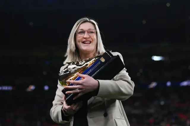 Former England striker Ellen White collects her golden boot.