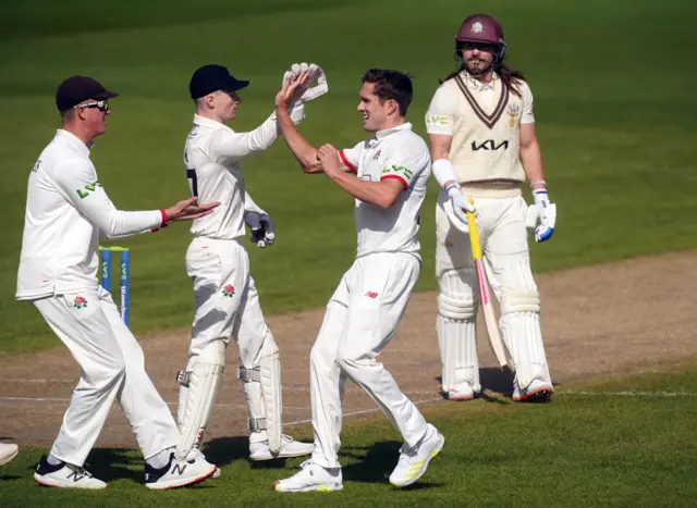 Lancashire celebrate the wicket of Rory Burns