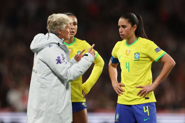 Pia Sundhage gives instructions to her Brazil players.