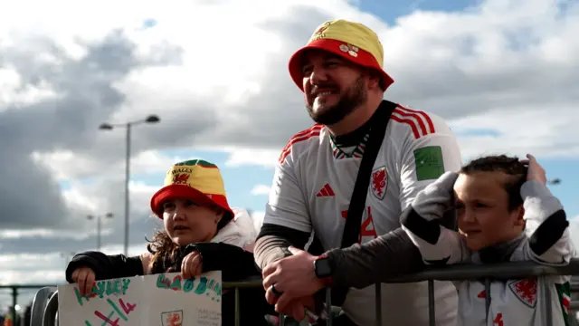 Wales fans await the players' arrival at the Cardiff City Stadium