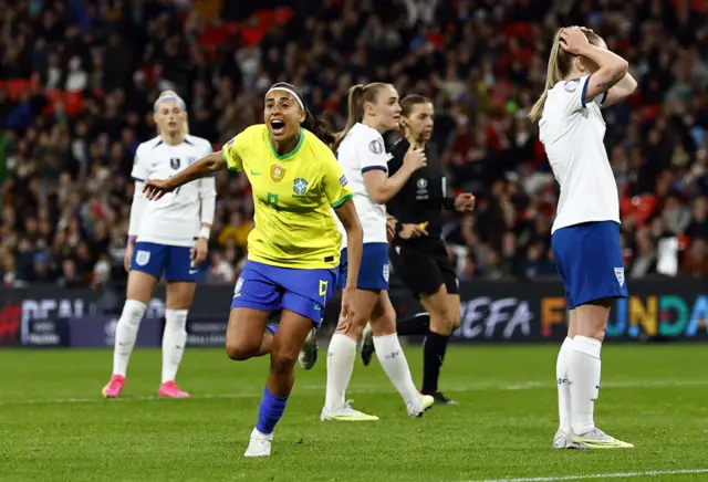 Brazil celebrate their late leveller.