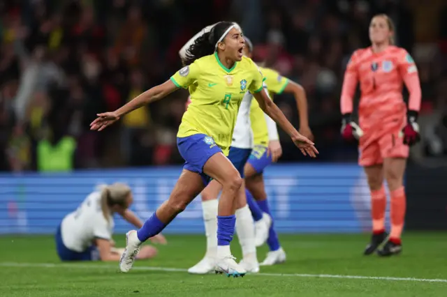 Alves celebrates scoring a late leveller for Brazil.