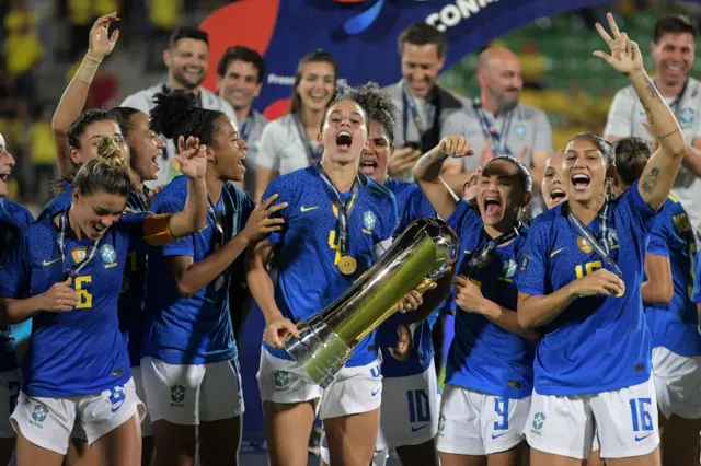 Brazil captain Rafaelle Souza lifts the Copa America trophy.