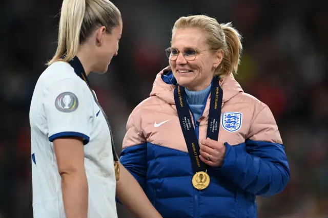 Sarina Wiegman celebrates with one of her England players.