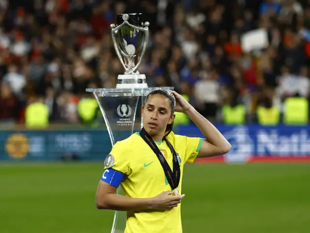 Brazil captain Rafaelle walks sadly past the trophy after losing the Finalissima.