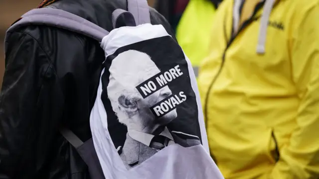 A person has a backpack with No More Royals written on it