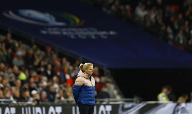 England boss Sarina Wiegman watches on.