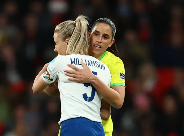 Leah Williamson consoles her clubmate Rafaelle Souza.