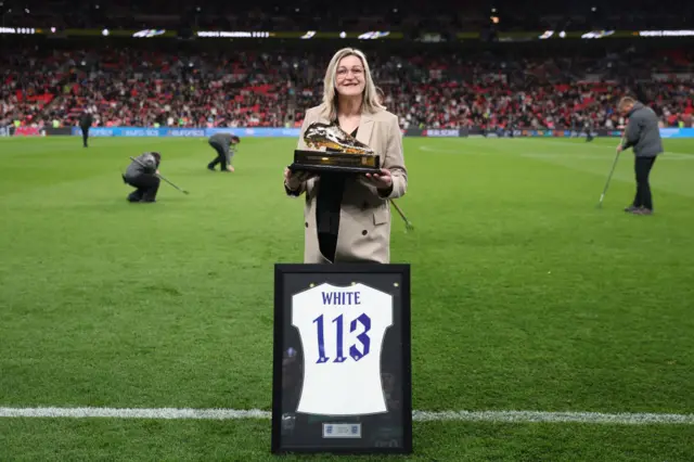 Ellen White is presented with a legacy shirt for her England career.