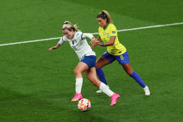 Lauren Hemp evades Brazil pressure.