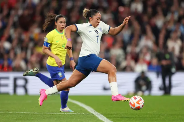 Lauren James evades a Brazil defender.