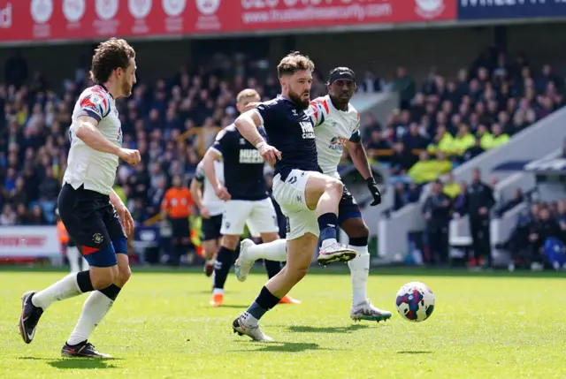 Millwall's Tom Bradshaw tries to get a shot away