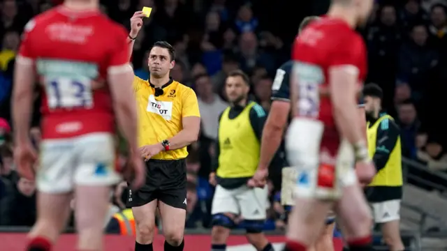 Referee shows a yellow card