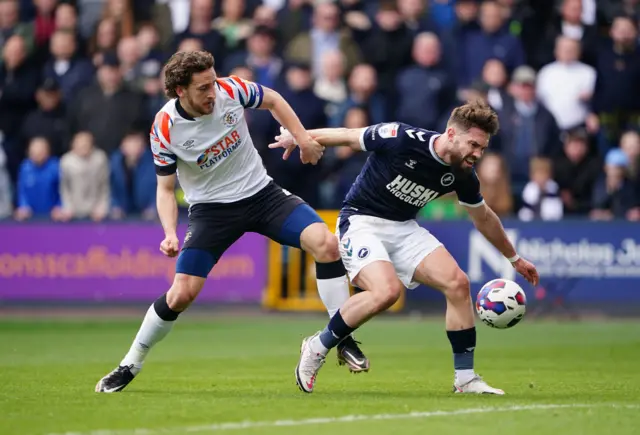 Millwall's Tom Bradshaw tries to get away from Luton's Tom Lockyer