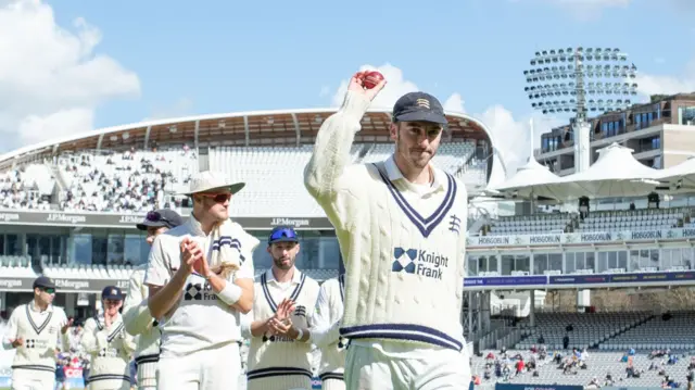 Toby Roland-Jones acknowledges the crowd following his 7-61 for Middlesex against Essex