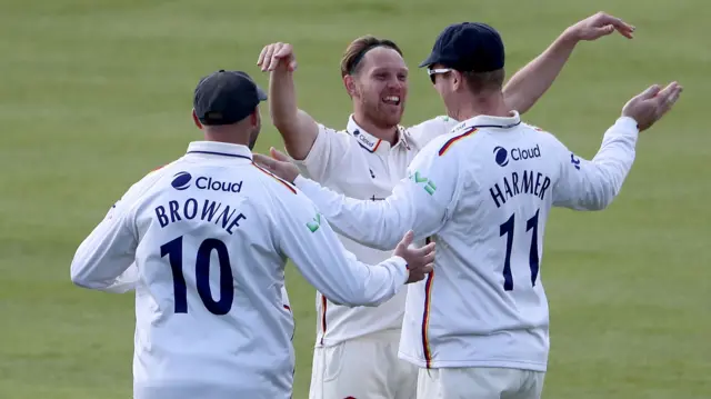 Jamie Porter of Essex celebrates taking the wicket of Middlesex's Max Holden