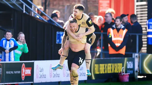 League Two leaders Leyton Orient celebrate scoring at Salford