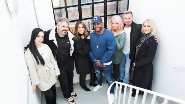 S Club 7 pictured on a staircase