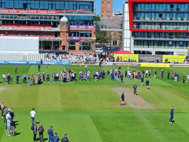 Crowd watching England players go through a training routine