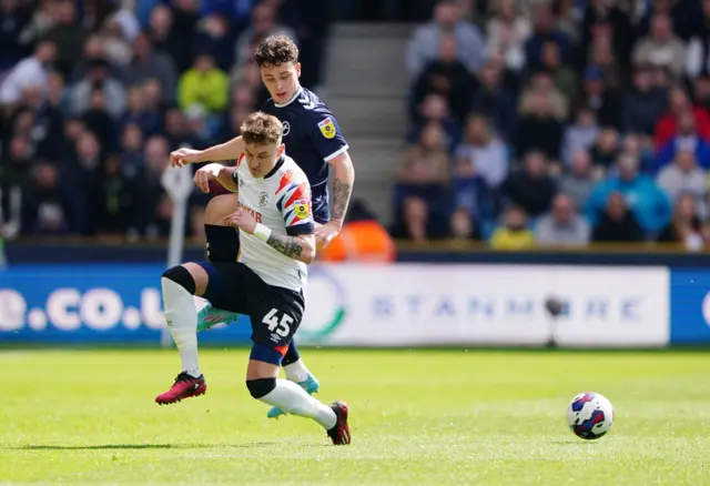 Millwall's Danny McNamara and Luton's Alfie Doughty challenge for the ball