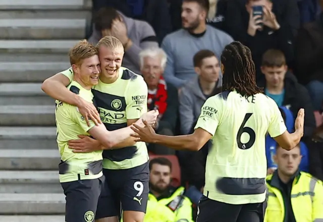 Erling Braut Haaland celebrates scoring their first goal with Kevin De Bruyne