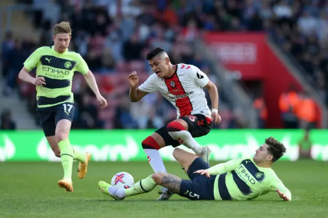 Carlos Alcaraz of Southampton is fouled by John Stones