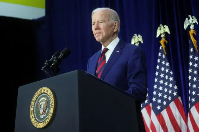 President Biden seen speaking from a podium