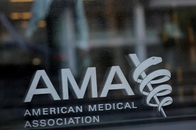 The logo of the American Medical Association seen printed on a window