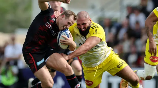 Max Malins of Saracens is tackled