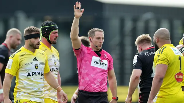 Referee Andrew Brace signals