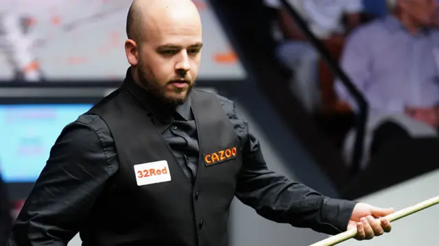 Luca Brecel prepares to play a shot