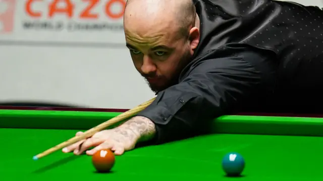 Luca Brecel plays a shot