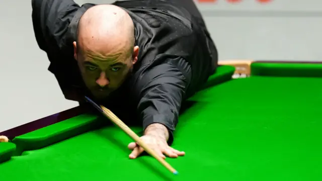 Luca Brecel plays a shot