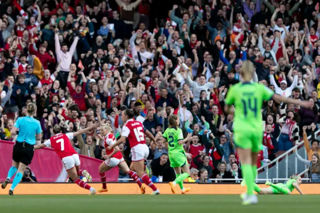 Arsenal players wheel away to celebrate.