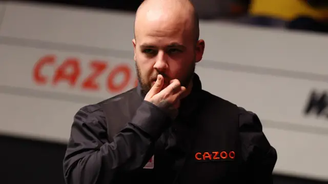 Luca Brecel scratches his beard