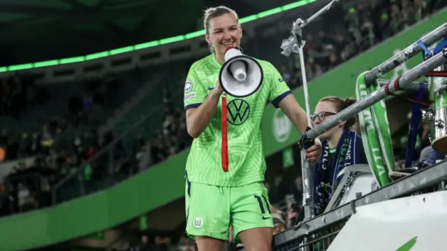 Wolfsburg player Alexandra Popp speaking through a megaphone