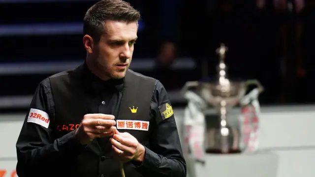 Mark Selby chalks his cue