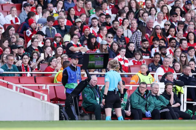 The referee heads to the VAR monitor.