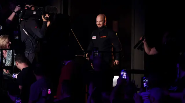 Luca Brecel enters the arena