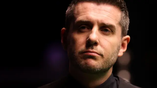 Mark Selby looks on