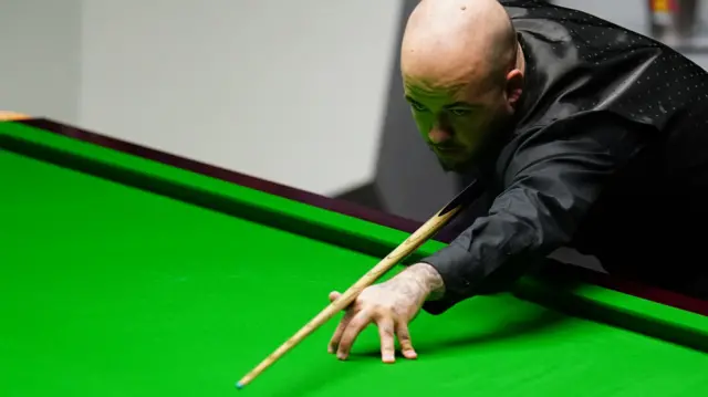 Luca Brecel plays a shot